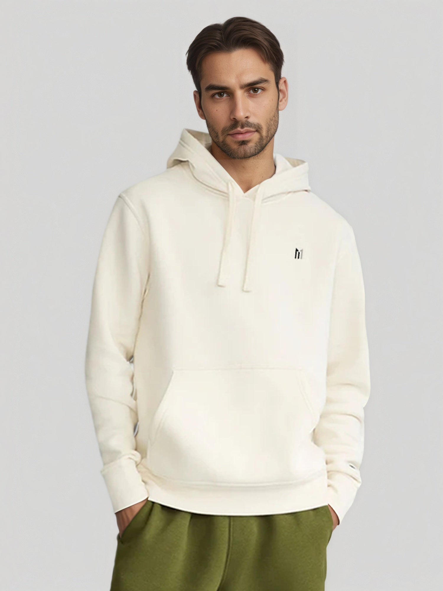 Man wearing white hoodie with front pocket and logo